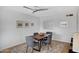 Cozy dining room with a wooden table, four chairs, and a patterned rug at 6873 E Vernon Ave, Scottsdale, AZ 85257