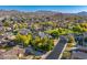 Expansive aerial view of a neighborhood with lush landscaping and mountain views at 6960 E Ivyglen St, Mesa, AZ 85207