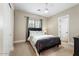 Comfortable bedroom featuring a well-lit window, neutral walls, and plush carpet for relaxation at 6960 E Ivyglen St, Mesa, AZ 85207