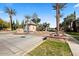 Welcoming community entrance with charming architecture, vibrant flower beds, and well-maintained landscaping at 6960 E Ivyglen St, Mesa, AZ 85207