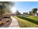 Scenic community park view showcasing lush green space, walking path, and recreational area under a sunny sky at 6960 E Ivyglen St, Mesa, AZ 85207