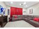 Cozy entertainment room with comfortable leather seating and a large television at 6960 E Ivyglen St, Mesa, AZ 85207
