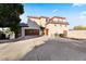 Beautiful two-story home with a grand entrance, attached garage, and a spacious driveway at 6960 E Ivyglen St, Mesa, AZ 85207