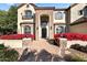 Grand entrance with stone accents, arched doorway, and vibrant landscaping for a striking first impression at 6960 E Ivyglen St, Mesa, AZ 85207