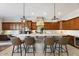 Large kitchen island with barstool seating and overhead pendant lighting at 6960 E Ivyglen St, Mesa, AZ 85207