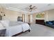 Large bedroom with a ceiling fan, neutral walls, and access to an ensuite bath at 6960 E Ivyglen St, Mesa, AZ 85207