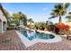 Inviting pool surrounded by lush greenery, a patio area, and comfortable seating for outdoor relaxation at 6960 E Ivyglen St, Mesa, AZ 85207