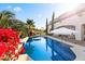 Sparkling swimming pool surrounded by lush landscaping and a patio with lounge area for relaxation at 6960 E Ivyglen St, Mesa, AZ 85207