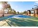 An outdoor tennis court at the edge of a community, basketball hoops are also present at 6960 E Ivyglen St, Mesa, AZ 85207