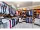 Spacious walk-in closet featuring custom shelving, hanging rods, and ample storage space for clothes and accessories at 6960 E Ivyglen St, Mesa, AZ 85207