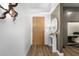 Inviting entryway featuring wood-look floors and stylish console table, complemented by a striking wall art piece at 7161 E Rancho Vista Dr # 1011, Scottsdale, AZ 85251