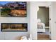 A view into the bedroom from the living area with a fireplace and mounted TV at 7161 E Rancho Vista Dr # 1011, Scottsdale, AZ 85251