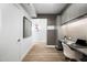 Bright hallway with wood-look floors, leading to a home office with stylish built-ins and decor at 7161 E Rancho Vista Dr # 1011, Scottsdale, AZ 85251