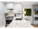 Well-appointed kitchen features a marble countertop, stainless steel appliances, and modern white cabinetry at 7161 E Rancho Vista Dr # 1011, Scottsdale, AZ 85251
