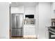 Contemporary kitchen boasts stainless steel refrigerator, built-in microwave, and modern white cabinetry at 7161 E Rancho Vista Dr # 1011, Scottsdale, AZ 85251