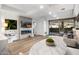 Open floor plan offers a modern fireplace, entertainment system, and sliding door access to the patio at 7161 E Rancho Vista Dr # 1011, Scottsdale, AZ 85251