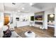 Open concept living area with a modern fireplace, TV, kitchen, and dining space at 7161 E Rancho Vista Dr # 1011, Scottsdale, AZ 85251