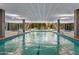 Indoor pool featuring tiled flooring, bright lighting, and a serene, modern design with views of the outdoors at 7161 E Rancho Vista Dr # 1011, Scottsdale, AZ 85251