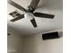 A modern ceiling fan with a light fixture complements the contemporary design and features air conditioner in the room at 7311 W Globe Ave, Phoenix, AZ 85043