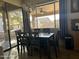 Dining area with large window and dark wood table with seating for six, view of backyard at 7311 W Globe Ave, Phoenix, AZ 85043