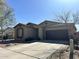 Charming single-story home featuring desert landscaping, a two-car garage, and a neutral color palette at 7311 W Globe Ave, Phoenix, AZ 85043