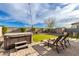 Relaxing backyard with a hot tub, artificial grass, paved area with lounge chairs, and ambient string lights at 7533 S Woodchute Dr, Gold Canyon, AZ 85118
