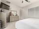 Cozy bedroom with a ceiling fan, carpet flooring, neutral decor, and a view of the dresser and mounted television at 7533 S Woodchute Dr, Gold Canyon, AZ 85118
