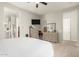 Spacious bedroom with a ceiling fan, neutral walls, carpet flooring, and access to a private bathroom at 7533 S Woodchute Dr, Gold Canyon, AZ 85118