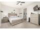 Comfortable bedroom with a ceiling fan, neutral color scheme, and a view into the adjacent bathroom at 7533 S Woodchute Dr, Gold Canyon, AZ 85118