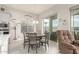 Bright dining area with a view of the backyard, tile flooring, and a table with seating for six at 7533 S Woodchute Dr, Gold Canyon, AZ 85118