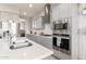 Well-equipped kitchen showcasing stainless steel appliances, white subway tile backsplash, and gray cabinetry at 7533 S Woodchute Dr, Gold Canyon, AZ 85118