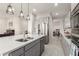 Stylish kitchen featuring stainless steel appliances, gray cabinets, quartz countertops, and modern pendant lighting at 7533 S Woodchute Dr, Gold Canyon, AZ 85118