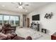 Spacious living room with a ceiling fan, tile floors, and a sliding glass door at 7533 S Woodchute Dr, Gold Canyon, AZ 85118