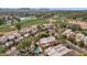 Expansive aerial view of the neighborhood with a community golf course, serene lakes, and mountain views at 7740 E Gainey Ranch Rd # 36, Scottsdale, AZ 85258