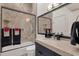 Modern bathroom featuring a shower/bathtub combination with framed glass doors and a black vanity at 7740 E Gainey Ranch Rd # 36, Scottsdale, AZ 85258