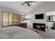 Well-lit bedroom with shuttered windows, neutral colors, and an open en-suite bathroom at 7740 E Gainey Ranch Rd # 36, Scottsdale, AZ 85258