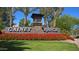 Welcoming Gainey Ranch community entrance sign with vibrant floral display and manicured landscaping under a clear blue sky at 7740 E Gainey Ranch Rd # 36, Scottsdale, AZ 85258