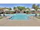 Large community pool with ample lounge chairs and shaded seating areas for residents to enjoy at 7740 E Gainey Ranch Rd # 36, Scottsdale, AZ 85258
