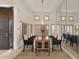 Elegant dining room with travertine floors, shutters, and a mirrored wall at 7740 E Gainey Ranch Rd # 36, Scottsdale, AZ 85258