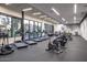 Bright, spacious gym boasts rows of treadmills and elliptical machines with large windows overlooking the outdoors at 7740 E Gainey Ranch Rd # 36, Scottsdale, AZ 85258