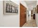 Hallway with wood closet doors and stone tile floors at 7740 E Gainey Ranch Rd # 36, Scottsdale, AZ 85258