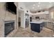 Kitchen featuring an island, stainless steel appliances, and a fireplace at 7740 E Gainey Ranch Rd # 36, Scottsdale, AZ 85258