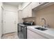 Functional laundry room with stainless steel appliances, ample storage, and a sink at 7740 E Gainey Ranch Rd # 36, Scottsdale, AZ 85258