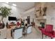 Bright living room with tall ceilings, stone fireplace, and travertine accents at 7740 E Gainey Ranch Rd # 36, Scottsdale, AZ 85258