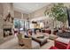 Spacious living room with high ceilings, a stone fireplace, and abundant natural light at 7740 E Gainey Ranch Rd # 36, Scottsdale, AZ 85258