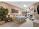 Main bedroom with a fireplace, ceiling fan, and natural lighting at 7740 E Gainey Ranch Rd # 36, Scottsdale, AZ 85258