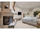 Main bedroom with a fireplace, ceiling fan, and artwork at 7740 E Gainey Ranch Rd # 36, Scottsdale, AZ 85258