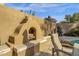 Outdoor fireplace with unique Southwest style, complete with logs for burning and sitting area to enjoy the Arizona evenings at 7740 E Gainey Ranch Rd # 36, Scottsdale, AZ 85258