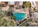 Aerial view of a beautiful private backyard pool surrounded by lush desert landscaping and lounge furniture at 7740 E Gainey Ranch Rd # 36, Scottsdale, AZ 85258