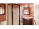 Bathroom with a frosted shower, vanity, mirror, and stylish orange walls at 834 S Beryl Dr, Apache Junction, AZ 85119